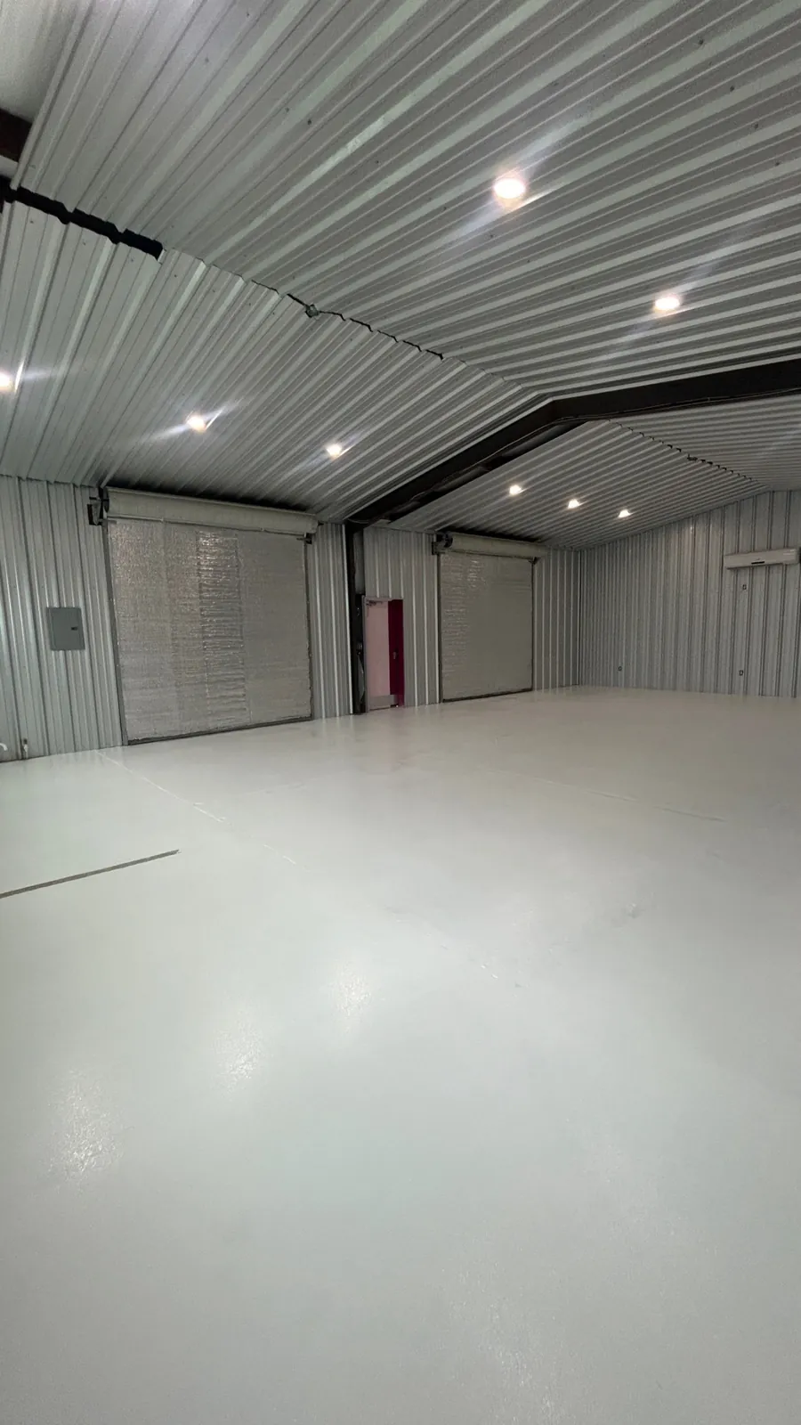 Coated warehouse floor running the length of a multi-bay building