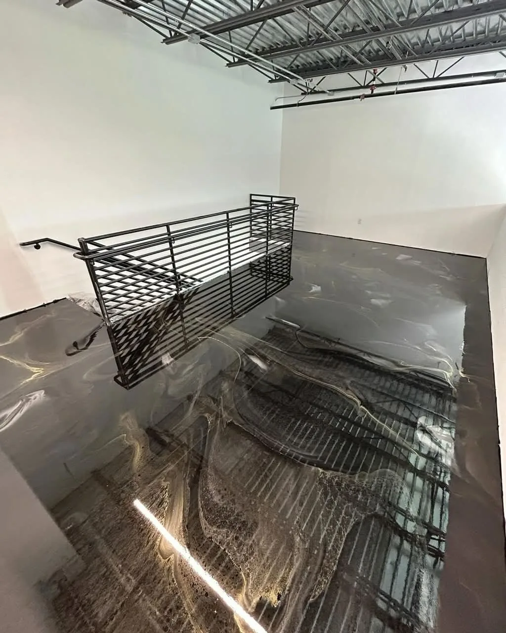 Commercial metallic epoxy floor in a warehouse space